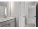 Bathroom view showcasing the vanity, mirror, and a glimpse into another room at 60 Accord Dr, Youngsville, NC 27596