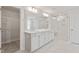 Bright bathroom with double vanity, white cabinets, and a glass shower at 60 Accord Dr, Youngsville, NC 27596
