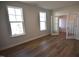 Bedroom featuring two windows for ample light and an open door at 60 Accord Dr, Youngsville, NC 27596