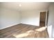 Bright bedroom with hardwood floors, and an open door at 60 Accord Dr, Youngsville, NC 27596