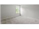 A well-lit bedroom with a window offering natural light and neutral-toned carpeting at 60 Accord Dr, Youngsville, NC 27596