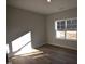 Bright bedroom features a window that provides natural light and wood-style laminate flooring at 60 Accord Dr, Youngsville, NC 27596