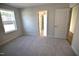 Bedroom with gray carpet, natural light from the window, and an open doorway at 60 Accord Dr, Youngsville, NC 27596