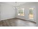 Open dining area with wood floors, a modern chandelier, and access to the porch at 60 Accord Dr, Youngsville, NC 27596