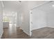 Bright hallway featuring wood floors and an open view of the kitchen at 60 Accord Dr, Youngsville, NC 27596