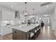 Beautiful kitchen with stainless steel appliances, island with bar seating and pendant lighting at 60 Accord Dr, Youngsville, NC 27596