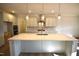 Bright kitchen featuring a large island, modern pendant lighting, and stainless steel appliances at 60 Accord Dr, Youngsville, NC 27596