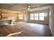 Open-concept living room and kitchen area, with hardwood flooring, island, and natural light at 60 Accord Dr, Youngsville, NC 27596