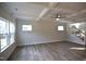Open living room with coffered ceiling, hardwood floors, and large windows for natural light at 60 Accord Dr, Youngsville, NC 27596