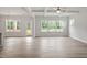Bright living room featuring wood floors, large windows, and an access to the porch at 60 Accord Dr, Youngsville, NC 27596
