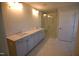 Well-lit main bathroom featuring a double vanity, marble floors, and walk-in shower at 60 Accord Dr, Youngsville, NC 27596