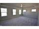 Spacious main bedroom with neutral carpet, tray ceiling, and large windows at 60 Accord Dr, Youngsville, NC 27596