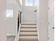 Stairway with wood and white steps and a dark railing at 60 Accord Dr, Youngsville, NC 27596