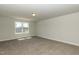 Spacious, carpeted room with a large window offering natural light and neighborhood views at 68 Streamline Ct, Lillington, NC 27546
