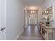 Inviting entryway with wood floors, console table with decor, and a view of the front door at 68 Streamline Ct, Lillington, NC 27546