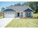 Two-story home with stone accents and a two-car garage at 68 Streamline Ct, Lillington, NC 27546