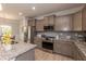 Stylish kitchen with stainless steel appliances, granite countertops, and gray cabinets at 68 Streamline Ct, Lillington, NC 27546