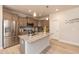 Modern kitchen with stainless appliances, granite island, and stylish pendant lighting at 68 Streamline Ct, Lillington, NC 27546