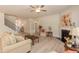 Cozy living room with fireplace, neutral furniture, and a view of the staircase at 68 Streamline Ct, Lillington, NC 27546