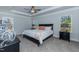 Relaxing main bedroom with tray ceiling, neutral tones, and natural light from windows at 68 Streamline Ct, Lillington, NC 27546