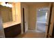Bathroom featuring tile floors, a single sink vanity with mirror, and doorway to adjacent bedroom at 70 Accord Dr, Youngsville, NC 27596