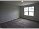 Neutral bedroom featuring carpet flooring, natural light, and ample space for furniture at 70 Accord Dr, Youngsville, NC 27596