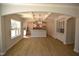 Open-concept living space with hardwood floors, coffered ceiling, and views into the kitchen at 70 Accord Dr, Youngsville, NC 27596