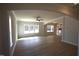 Spacious living room with hardwood floors, neutral walls, ceiling fan, and natural light at 70 Accord Dr, Youngsville, NC 27596