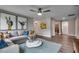 Modern living room featuring gray sofa, blue accents, and colorful artwork at 70 Accord Dr, Youngsville, NC 27596