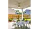 Covered patio with a ceiling fan and four chairs overlooking the backyard at 75 Calabria Ct, Franklinton, NC 27525