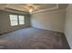 Spacious bedroom with a tray ceiling, carpeted floors, and large windows at 75 Calabria Ct, Franklinton, NC 27525