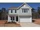 Charming two-story home featuring gray siding, white trim, and an attached two-car garage at 75 Calabria Ct, Franklinton, NC 27525