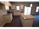 Modern kitchen featuring a large island, stainless steel appliances, and an open layout at 75 Calabria Ct, Franklinton, NC 27525