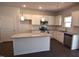 Modern kitchen features white cabinets, granite countertops, stainless steel appliances, and an island at 75 Calabria Ct, Franklinton, NC 27525