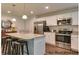 Kitchen with granite countertops, stainless steel appliances and island with bar stool seating at 75 Calabria Ct, Franklinton, NC 27525