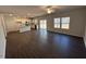 Open-concept living room and kitchen featuring modern finishes and natural light at 75 Calabria Ct, Franklinton, NC 27525