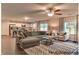 Open-concept living room featuring hardwood floors, a modern ceiling fan, and a cozy sectional sofa at 75 Calabria Ct, Franklinton, NC 27525