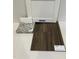 Material samples featuring a white Elkins cabinet door, granite, and Hearsville Plus vinyl flooring at 75 Calabria Ct, Franklinton, NC 27525