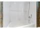 Clean bathroom with white tile and a shower/tub combo at 7516 Wingfoot Dr, Raleigh, NC 27615