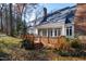 Back exterior view of the house showcasing deck and landscaping at 7516 Wingfoot Dr, Raleigh, NC 27615