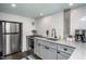 Modern gray kitchen with stainless steel appliances and herringbone backsplash at 807 E Edenton St, Raleigh, NC 27601