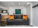 Basement sitting area featuring a grey couch and colorful artwork at 807 E Edenton St, Raleigh, NC 27601
