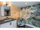 Stylish bathroom with a modern vanity, large mirror, and artistic wall mural at 807 E Edenton St, Raleigh, NC 27601