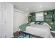 Main bedroom with a king-size bed and teal bedding at 807 E Edenton St, Raleigh, NC 27601