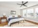 Bedroom with king-size bed, ceiling fan, hardwood floors, and large windows at 807 E Edenton St, Raleigh, NC 27601