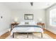 Bright bedroom with king-size bed, hardwood floors, and two nightstands at 807 E Edenton St, Raleigh, NC 27601