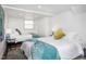 Guest bedroom with two twin beds and teal blanket at 807 E Edenton St, Raleigh, NC 27601