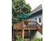 Elevated wooden deck with umbrella, table, chairs, and stairs leading down at 807 E Edenton St, Raleigh, NC 27601