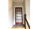 Red door with frosted glass panes, a gray rug and dark wood banister at 807 E Edenton St, Raleigh, NC 27601