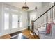 Bright entryway with hardwood floors, staircase, and ample natural light at 807 E Edenton St, Raleigh, NC 27601